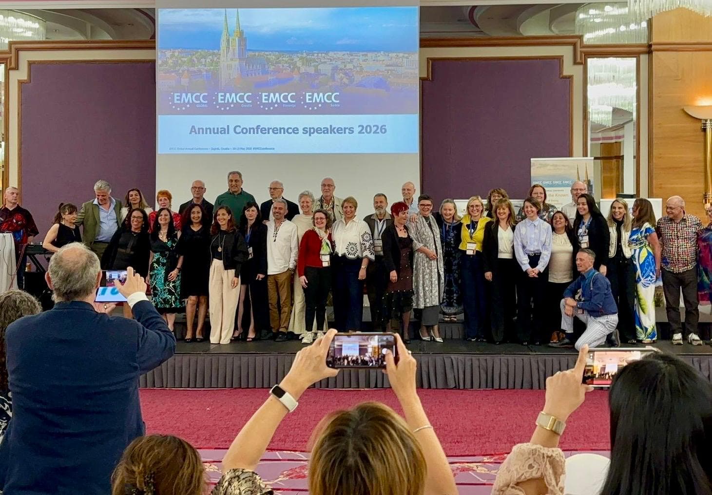 Group of EMCC Global Annual Conference 2026 speakers with attendees from 38 countries.